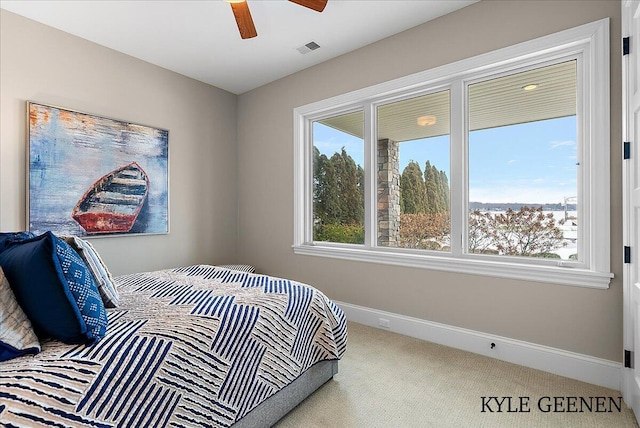bedroom featuring carpet floors, baseboards, visible vents, and a ceiling fan