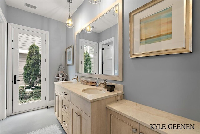 full bathroom with double vanity, visible vents, and a sink