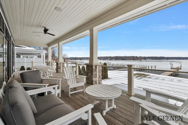 deck featuring a water view and a ceiling fan
