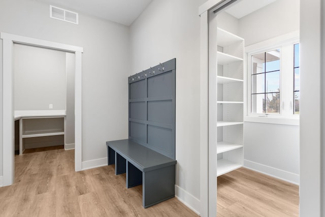 mudroom featuring wood finished floors, visible vents, and baseboards