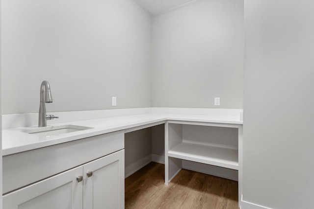 interior space with light wood-style floors and a sink