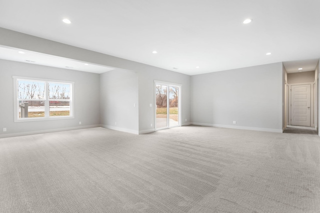 empty room with recessed lighting, baseboards, and light colored carpet