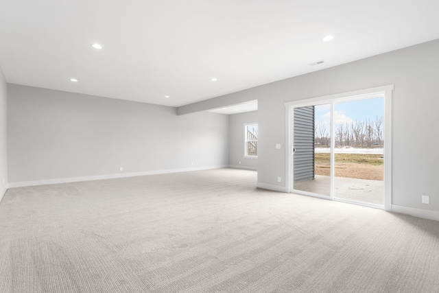 interior space featuring baseboards, recessed lighting, and light colored carpet