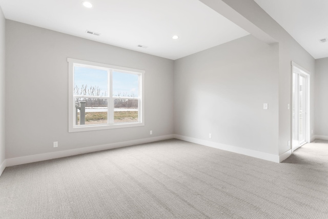 unfurnished room with recessed lighting, baseboards, visible vents, and light colored carpet