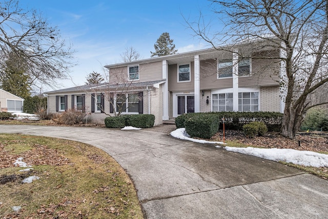 view of front of home with concrete driveway and brick siding