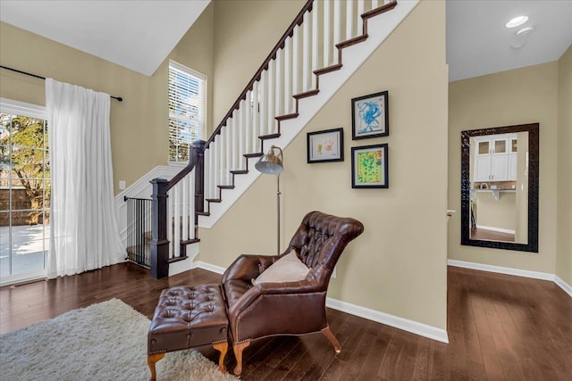 entrance foyer featuring stairway, hardwood / wood-style flooring, and baseboards