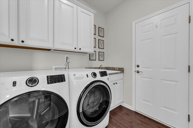 laundry area with dark wood-style floors, cabinet space, a sink, and separate washer and dryer