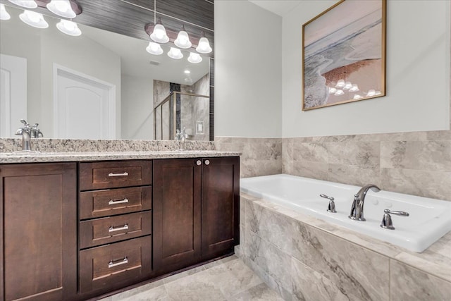 bathroom featuring a garden tub, double vanity, a sink, and a shower stall