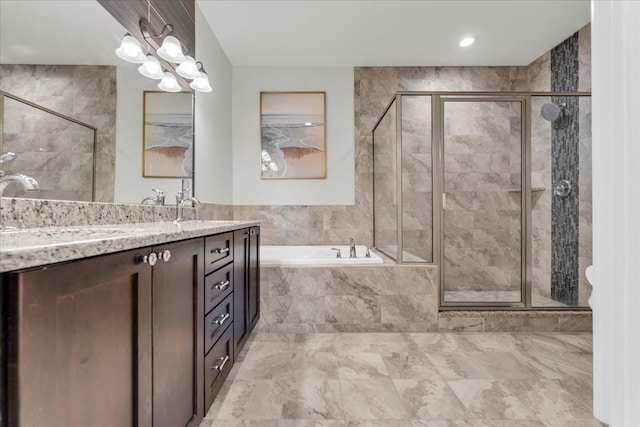 full bathroom with a stall shower, a garden tub, and vanity