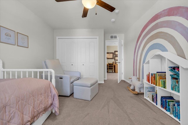 carpeted bedroom with a ceiling fan, a closet, visible vents, and baseboards