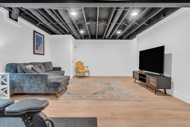 living area featuring baseboards and wood finished floors