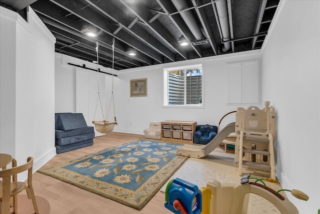 living area featuring visible vents, baseboards, and wood finished floors