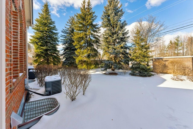 yard layered in snow featuring cooling unit