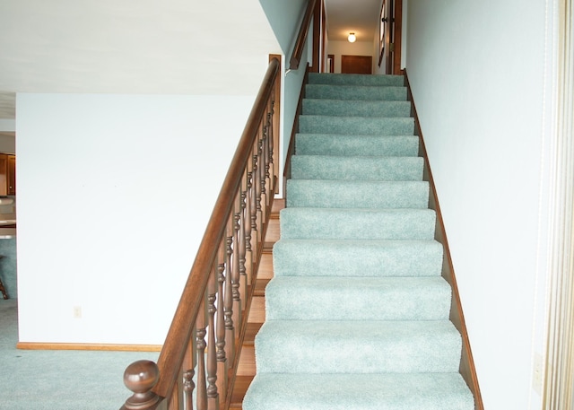 stairway featuring baseboards