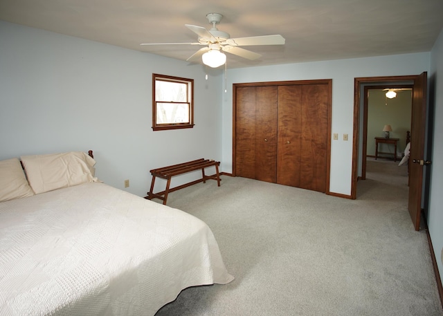 bedroom featuring carpet floors, ceiling fan, baseboards, and a closet