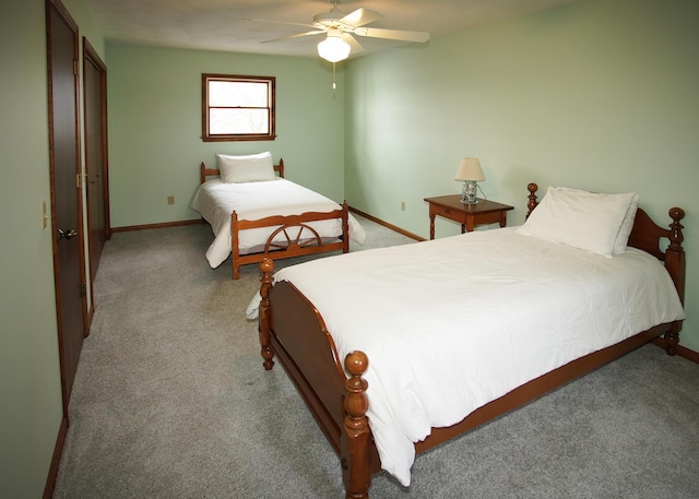 bedroom featuring baseboards, ceiling fan, and light colored carpet