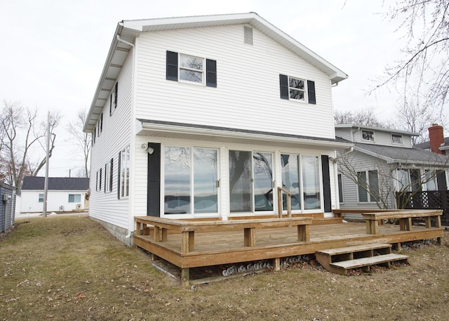 back of house with a deck