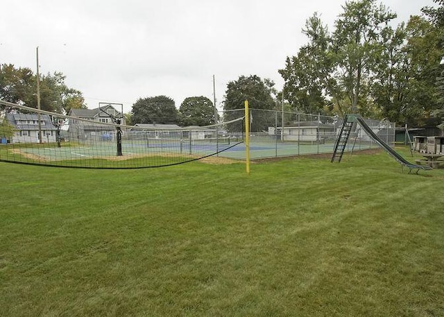 surrounding community with a tennis court, a yard, and fence