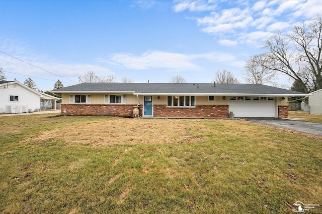 single story home featuring a garage, brick siding, aphalt driveway, and a front yard