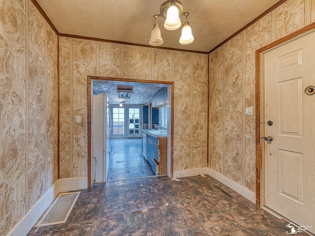 interior space featuring ornamental molding, visible vents, and a sink