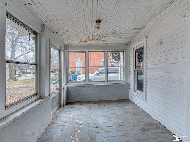 unfurnished sunroom featuring wooden ceiling and vaulted ceiling