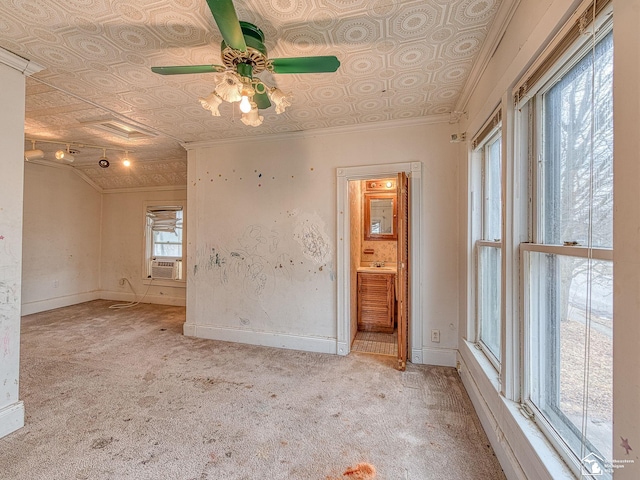 carpeted empty room with cooling unit, a ceiling fan, baseboards, ornamental molding, and an ornate ceiling