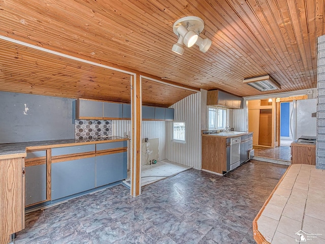 kitchen featuring a sink, wood ceiling, dishwasher, and freestanding refrigerator