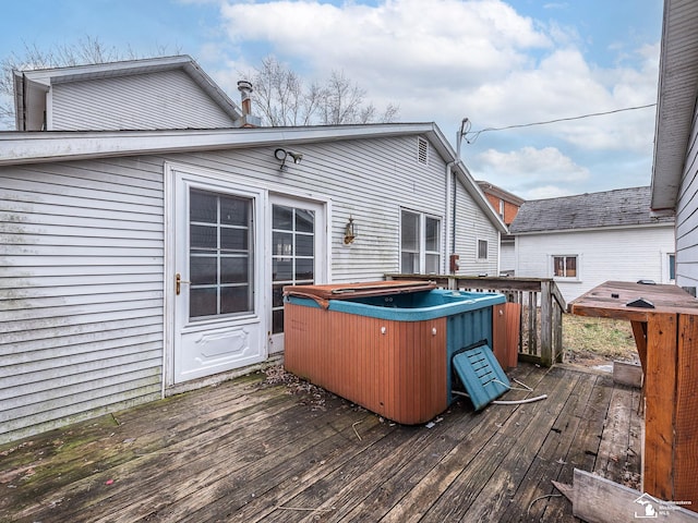 wooden deck featuring a hot tub