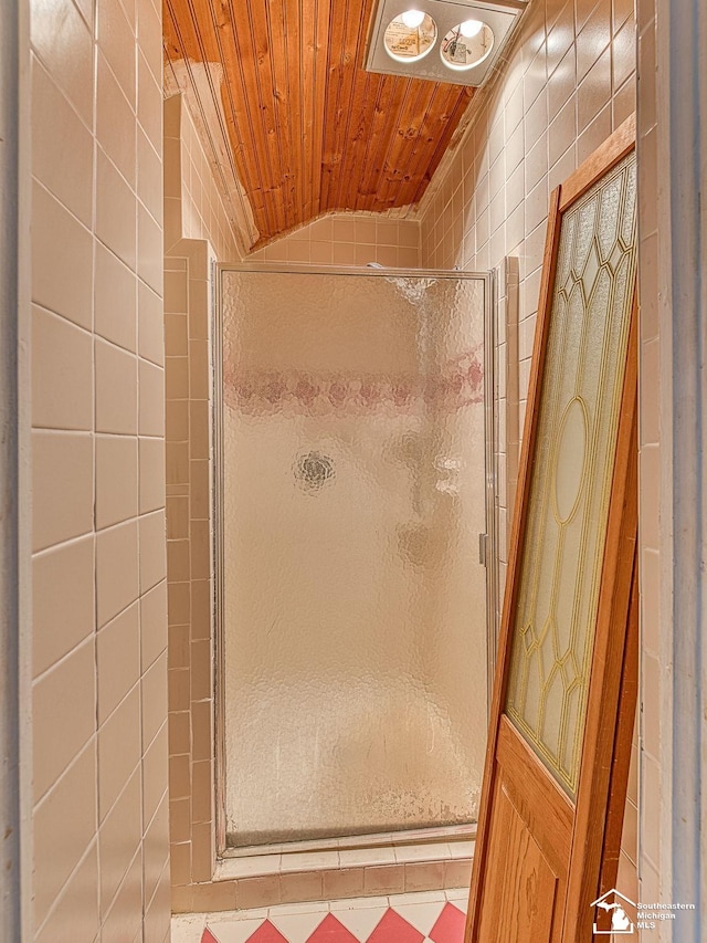 bathroom with lofted ceiling, wooden ceiling, and a shower stall