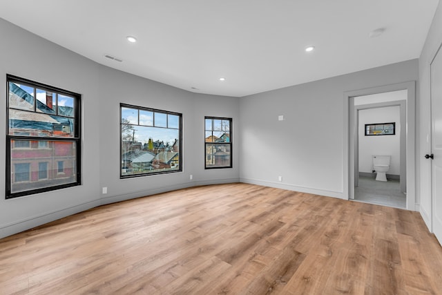 unfurnished room featuring recessed lighting, visible vents, light wood-style flooring, and baseboards