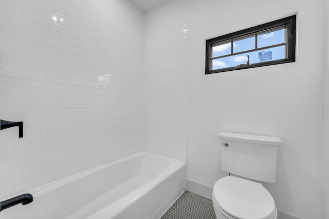 bathroom with toilet, shower / bath combination, tile patterned flooring, and baseboards