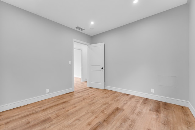 unfurnished room with recessed lighting, visible vents, baseboards, and wood finished floors