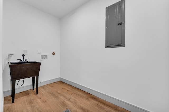 4301 Avery St, Detroit, MI 48208 - laundry room featuring electric panel, wood finished floors, hookup for a washing machine, and baseboards