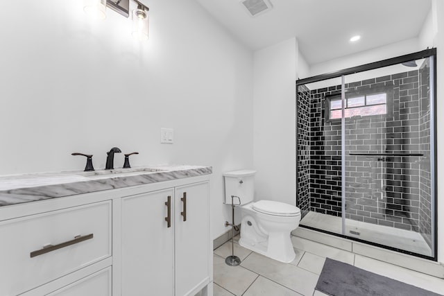 full bathroom with visible vents, toilet, vanity, a shower stall, and tile patterned floors