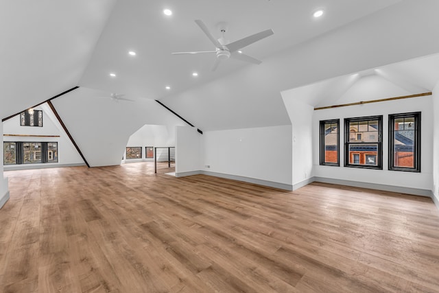 bonus room with a ceiling fan, lofted ceiling, and light wood-style flooring