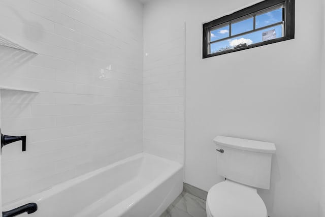 bathroom featuring marble finish floor, bathtub / shower combination, toilet, and baseboards