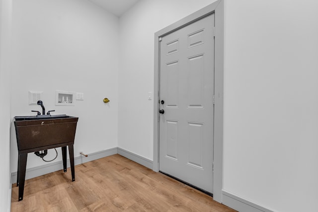 foyer with light wood-type flooring and baseboards