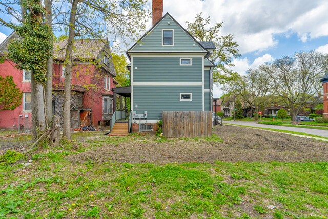 4301 Avery St, Detroit, MI 48208 - rear view of house featuring a chimney and fence
