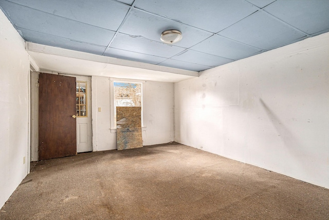 spare room with carpet and a paneled ceiling