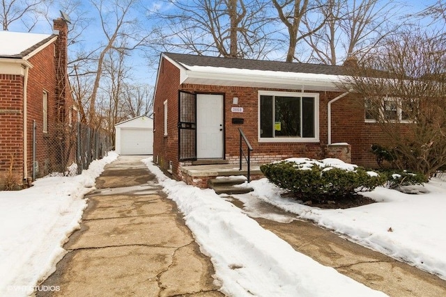 view of front of house featuring an outbuilding, brick siding, and a garage