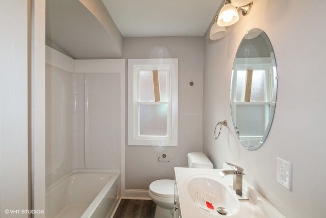 full bathroom with baseboards, toilet, wood finished floors, tub / shower combination, and vanity