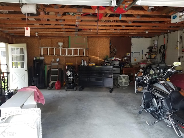 garage with a workshop area and a garage door opener