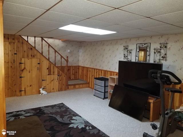 living room with a wainscoted wall, wallpapered walls, wooden walls, and carpet