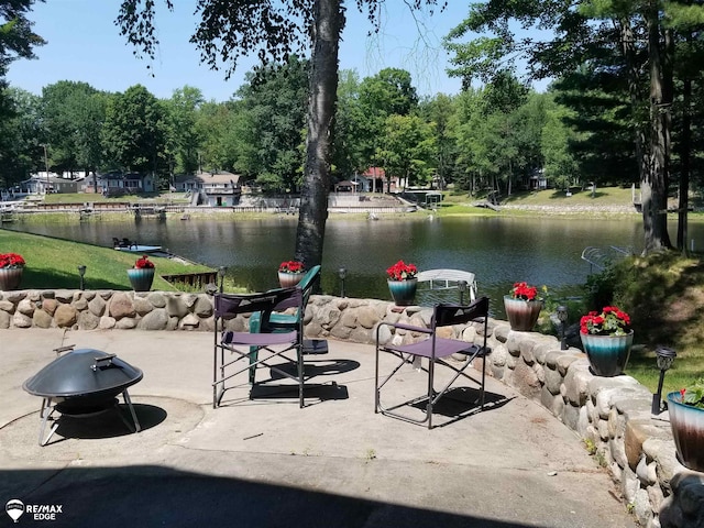 view of patio / terrace with a water view and an outdoor fire pit