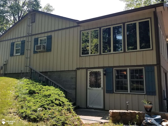 view of front of house featuring board and batten siding and cooling unit