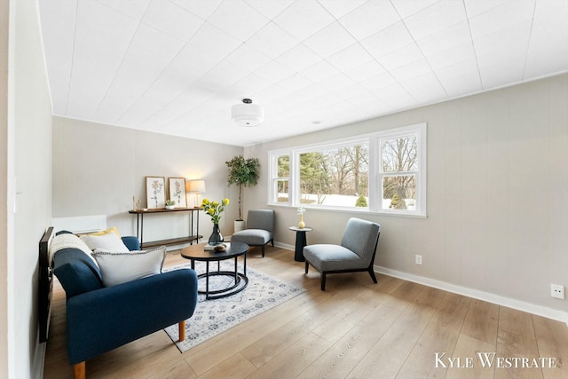 living area featuring baseboards and wood finished floors