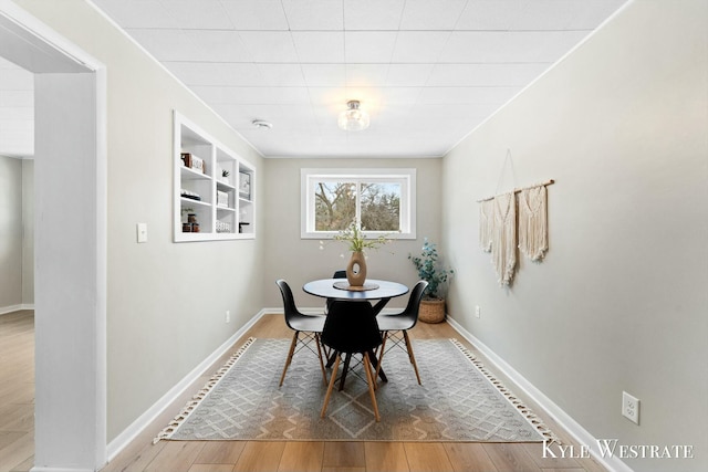 dining room featuring baseboards and wood finished floors