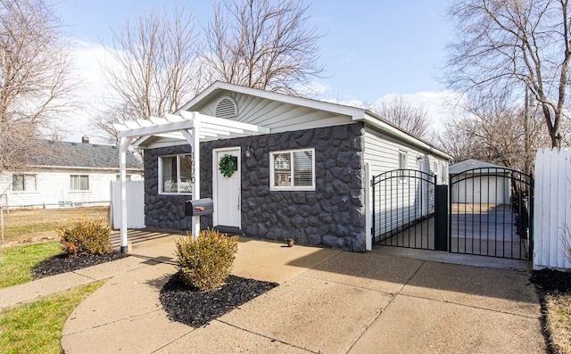 bungalow-style house with stone siding, a gate, fence, and a pergola