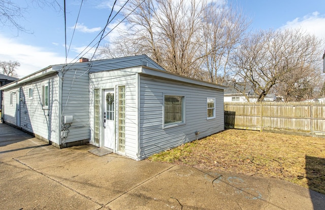 view of outbuilding featuring fence