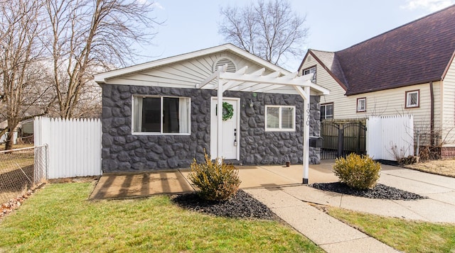 bungalow-style house featuring stone siding, a gate, roof with shingles, and fence